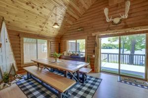 ein Esszimmer mit einem Tisch in einer Blockhütte in der Unterkunft Diamond Lake Waterfront Cabin with Deck and Dock! in Tustin