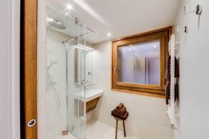 a bathroom with a glass shower and a sink at Croix du Sud in Val dʼIsère +11 photos