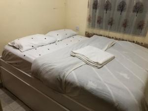 a large white bed with white sheets and pillows at Beths Haven in Ruiru