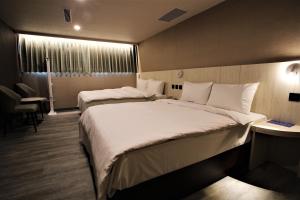 pokój hotelowy z 2 łóżkami i oknem w obiekcie Golden Home Hotel w Tajpej