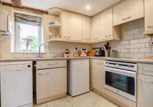 a kitchen with white appliances and a window at Dragonfly in Rumburgh