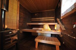 a sauna with a table and a bench in it at Hännilänsalmi Camping in Viitasaari