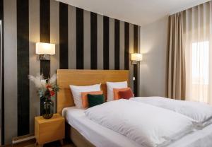 Postel nebo postele na pokoji v ubytování Hotel am Peterstor