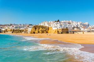 a view of a beach with people walking on the sand at Wonder Charm Guesthouse in Albufeira