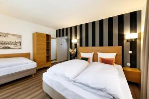 Postel nebo postele na pokoji v ubytování Hotel am Peterstor