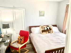 a bedroom with a bed and a desk and a chair at Beach Block Condo in Ventnor City