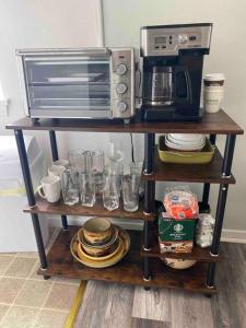 a microwave and a toaster oven on a shelf at Beach Block Condo in Ventnor City