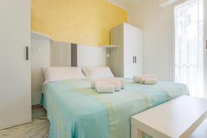 a bedroom with two beds with towels on them at Residence Mizar 2 in Pietra Ligure