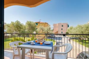 a table and chairs on a balcony with a view at Residence Mizar 2 in Pietra Ligure