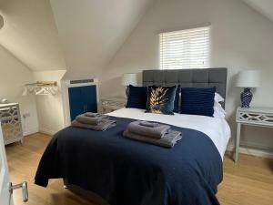 a bedroom with a large bed with towels on it at Monty Cottage, Exmouth Coastal Boutique House in Exmouth