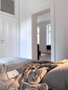 a bed with a blanket and a book on it at zehuus - historischer Charme in Cologne