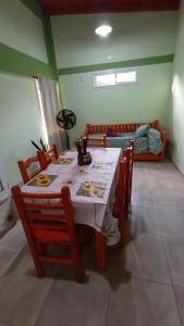 a dining room with a table and chairs and a couch at Los jacaranda in Cruz de Caña
