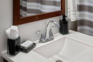 a bathroom sink with a faucet and a mirror at Large Fenced Yard and Outdoor Patio in Lewiston