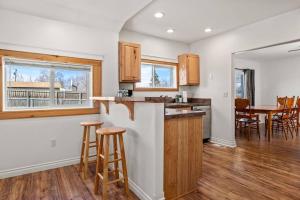 a kitchen with a bar and a dining room at Large Fenced Yard and Outdoor Patio in Lewiston