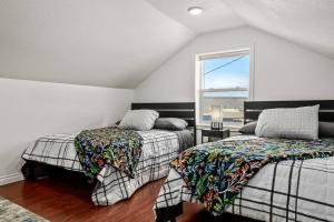 a bedroom with two beds and a window at Large Fenced Yard and Outdoor Patio in Lewiston