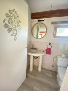 ein Bad mit einem Waschbecken und einem WC in der Unterkunft Cabañas Rústicas dentro de la Finca El Castillo in La Cabrera
