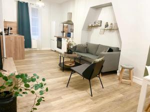 a living room with a couch and a table at Arina & Julien Dieppe in Dieppe
