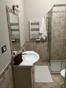 a bathroom with a sink and a shower at Garda Flow Holiday Home in Lonato del Garda