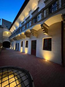 an empty courtyard of a building with a balcony at Residence Spillenberg Bridal Suite - Svadobna cesta in Levoča