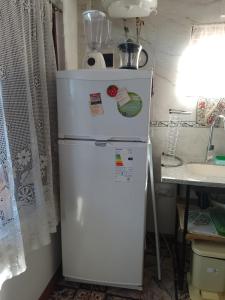 a white refrigerator with magnets on it in a kitchen at Flor de Lis in Puerto Iguazú