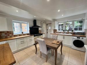 a kitchen with a wooden table and a dining room at Cosy Single Room for ONE person in Bromley