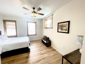 a bedroom with a bed and a ceiling fan at The Penthouse in Downtown in Fayetteville