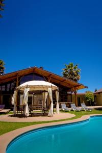 a resort with a tent and chairs and a pool at Parcela Olmué La Luz in Olmué