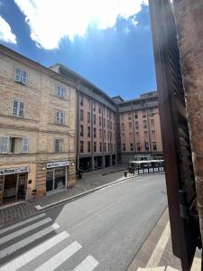 an empty street in front of a large building at Maison Sferisterio in Macerata