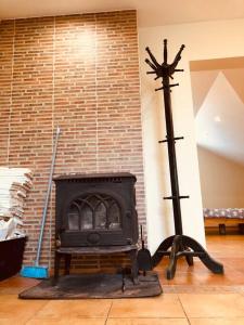 a fireplace in a living room next to a brick wall at Homely 2 room apartment in Liepāja