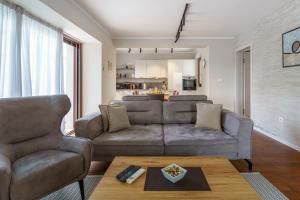 a living room with a couch and a table at Caprice in Milohnići