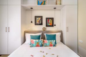 a bedroom with a bed with blue pillows at Caprice in Milohnići +36 photos