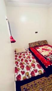 a bedroom with a bed and a quilt at حي لمسيرةا شارع الحيط in Tarfaya