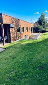 a building with a grass field in front of it at Villa Trondheim in Trondheim