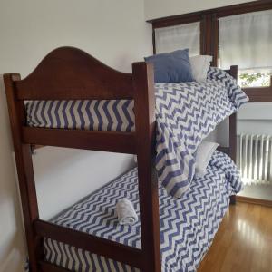 a couple of bunk beds in a room at Casa barrio Los Troncos "La Magnolia" in Mar del Plata