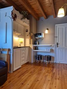 a kitchen with white cabinets and a wooden floor at Apartamento con encanto in Pla de l'Ermita