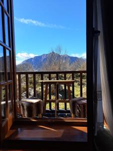 a room with a view of the mountains through a window at Apartamento con encanto in Pla de l'Ermita