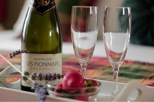 a bottle of wine and two glasses on a table at The Snowdonia Apartments in Llandudno