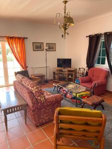 a living room with a couch and a table at Casa do Cabeço in Benedita