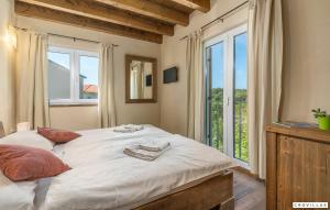 a bedroom with a large bed and a large window at Nocciola in Premantura +30 photos