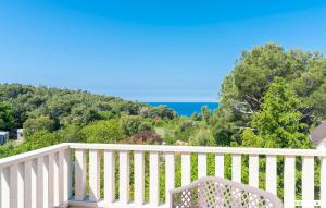 a white chair sitting on a balcony overlooking the ocean at Nocciola in Premantura