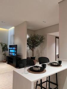 a kitchen with a table with chairs and a television at Luxury apartment with self check-in in Riyadh