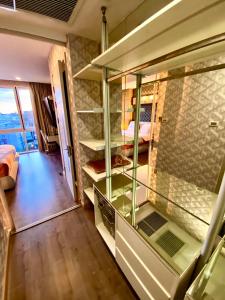 a room with glass shelves and a bedroom at Lux SL Luxury Style of Life in Pattaya Central