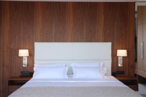 a bedroom with a large white bed with wooden walls at Celine in Savudrija +68 photos