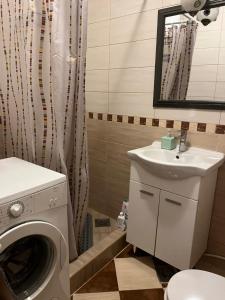 a bathroom with a washing machine and a sink at Be happy in Perast in Perast