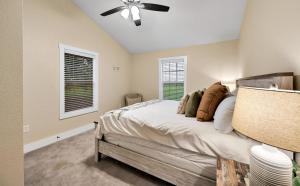 a bedroom with a bed and a ceiling fan at The Farmhouse 20 Min to Magnolia and Baylor in Waco