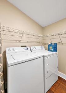 a white washer and dryer in a room at The Farmhouse 20 Min to Magnolia and Baylor in Waco