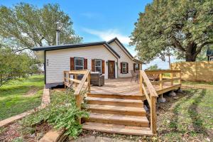 a home with a wooden deck and a house at The Farmhouse 20 Min to Magnolia and Baylor in Waco
