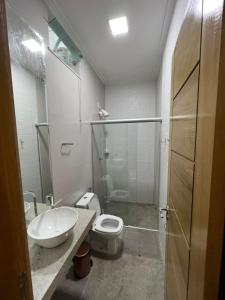 a bathroom with a sink and a toilet and a shower at STILLO AÇAI in Bragança
