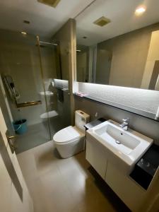 a bathroom with a toilet and a sink and a mirror at Lux SL Luxury Style of Life in Pattaya Central