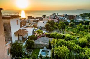 a view of a city at sunset at INSULA LUBRENSIS flat in Massa Lubrense